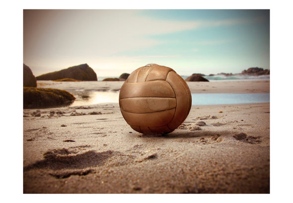Fotobehang - Een bal op een strand